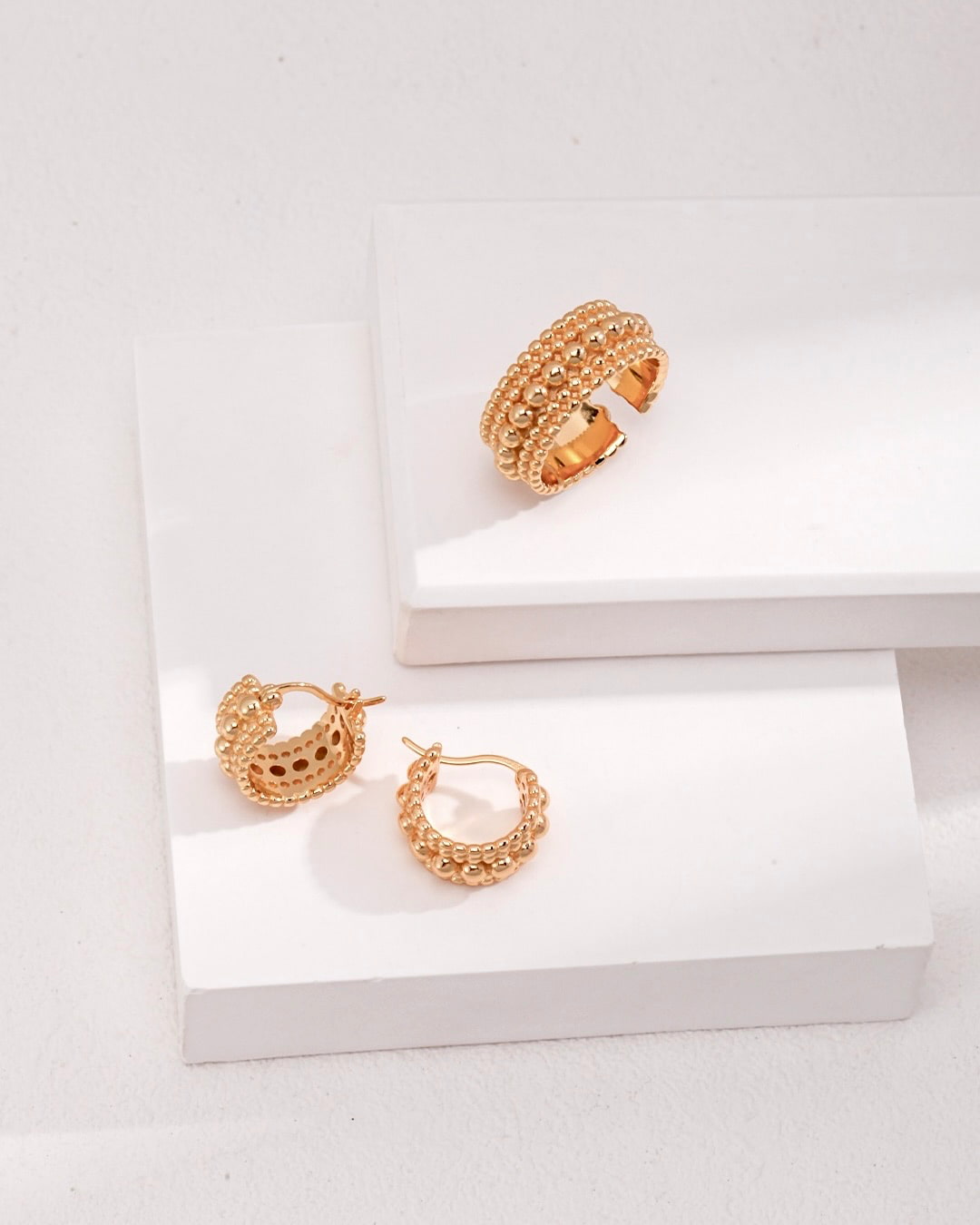 These best-selling hoop earrings feature unique bobble detailing. The chunky gold huggies add a distinctive touch to your style.