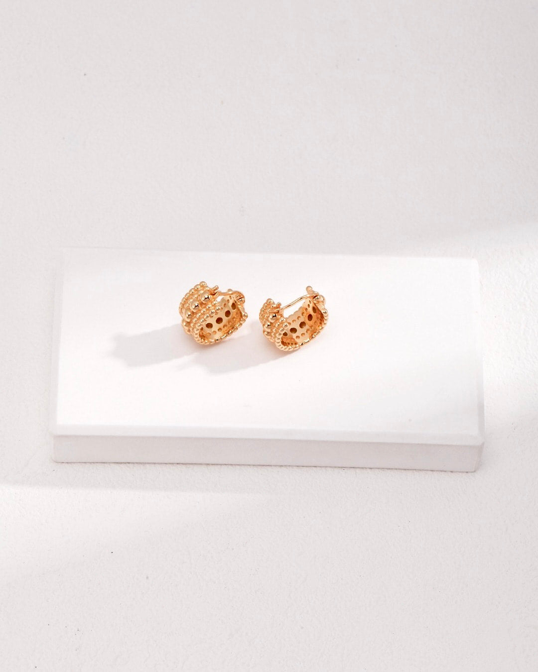 These best-selling hoop earrings feature unique bobble detailing. The chunky gold huggies add a distinctive touch to your style.