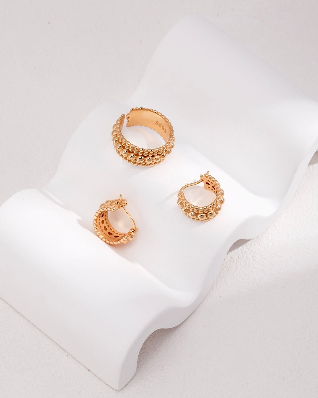 These best-selling hoop earrings feature unique bobble detailing. The chunky gold huggies add a distinctive touch to your style.